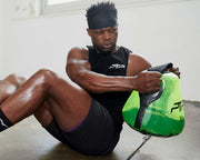 Man exercising with a ptp core kettle bell in a gym setting